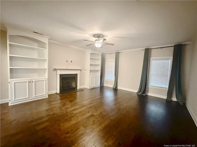 3014 Eaglecrest Ln, Fayetteville, NC 28306 - unfurnished living room with a ceiling fan, a fireplace with raised hearth, dark wood-style floors, built in features, and crown molding