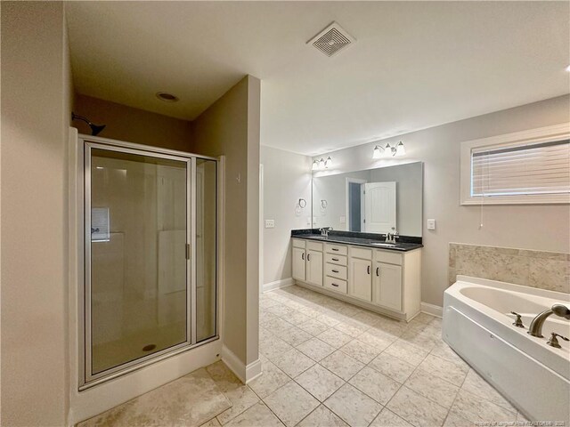 3014 Eaglecrest Ln, Fayetteville, NC 28306 - full bath featuring double vanity, a shower stall, a garden tub, and tile patterned floors