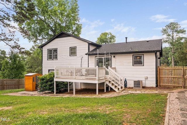 5400 Kaplan Dr, Raleigh, NC 27606 - back of property featuring a wooden deck, a fenced backyard, a storage unit, and stairway
