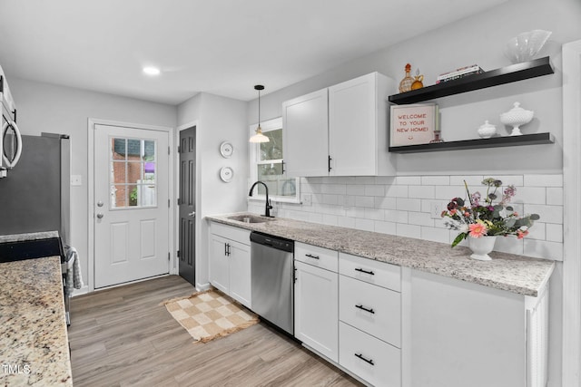 5400 Kaplan Dr, Raleigh, NC 27606 - kitchen featuring stainless steel appliances, white cabinetry, backsplash, light wood finished floors, and recessed lighting