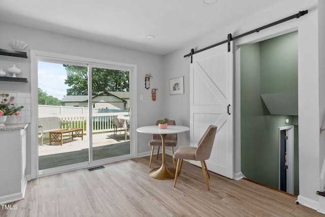5400 Kaplan Dr, Raleigh, NC 27606 - dining room featuring a barn door and light wood finished floors