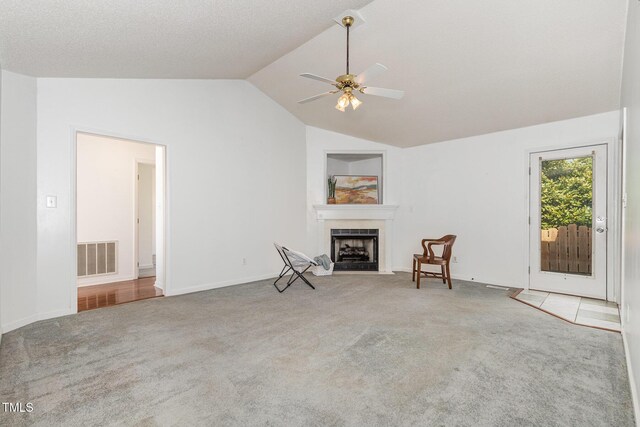 2312 Buckstone Ct, Fuquay Varina, NC 27526 - unfurnished room featuring carpet, lofted ceiling, a fireplace, and a ceiling fan