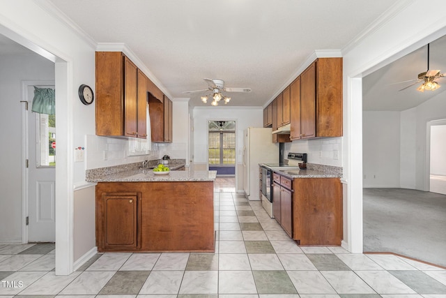 2312 Buckstone Ct, Fuquay Varina, NC 27526 - kitchen with stainless steel electric range, ceiling fan, brown cabinetry, and crown molding
