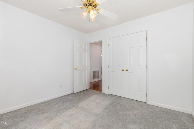 2312 Buckstone Ct, Fuquay Varina, NC 27526 - unfurnished bedroom with carpet flooring, a closet, and a ceiling fan