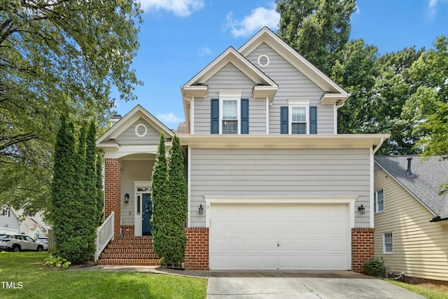 5301 Denmead Way, Raleigh, NC 27613 - traditional-style home with brick siding, an attached garage, and driveway