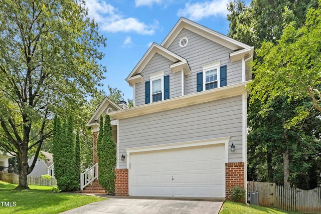 5301 Denmead Way, Raleigh, NC 27613 - traditional-style house with brick siding, driveway, and an attached garage