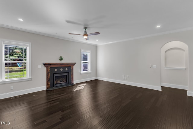 6332 Mountain Oaks Way, Wake Forest, NC 27587 - unfurnished living room featuring healthy amount of natural light, ceiling fan, dark wood-style floors, ornamental molding, and a fireplace with raised hearth