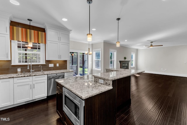 6332 Mountain Oaks Way, Wake Forest, NC 27587 - kitchen featuring appliances with stainless steel finishes, ornamental molding, recessed lighting, ceiling fan, and tasteful backsplash