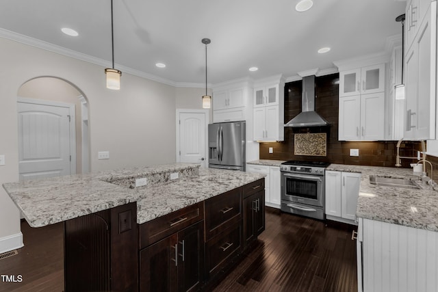 6332 Mountain Oaks Way, Wake Forest, NC 27587 - kitchen featuring appliances with stainless steel finishes, wall chimney range hood, crown molding, tasteful backsplash, and dark wood-type flooring
