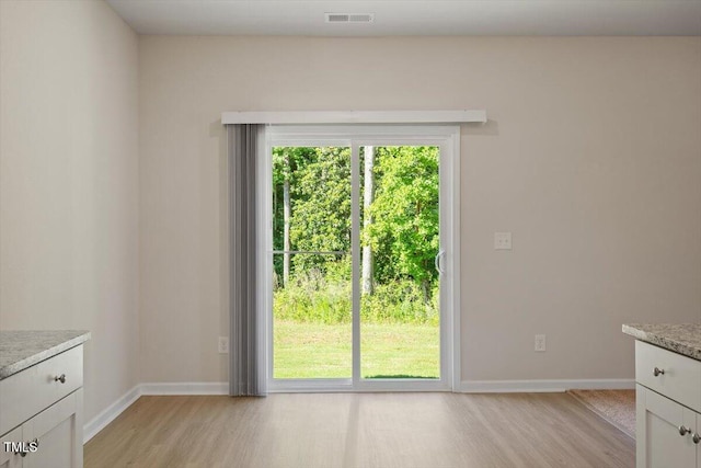 94 Taverners Ln, Angier, NC 27501 - unfurnished dining area with light wood-style floors and baseboards