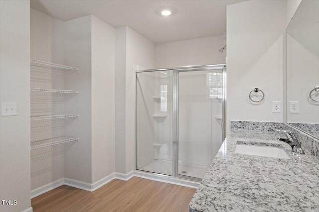94 Taverners Ln, Angier, NC 27501 - bathroom with wood finished floors, a stall shower, and double vanity