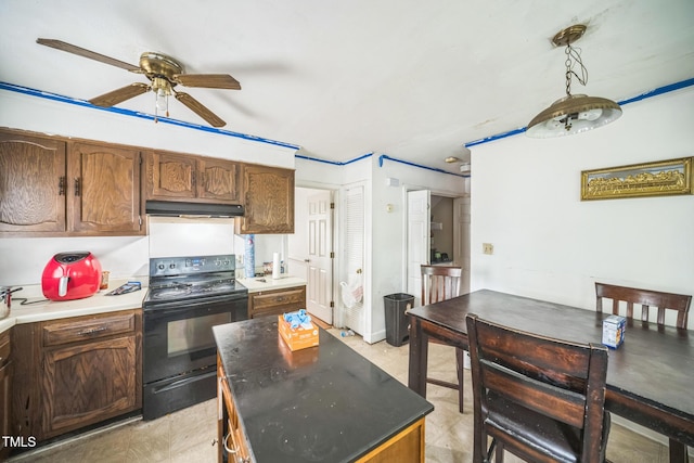 2504 Lancaster Rd NW, Wilson, NC 27896 - kitchen featuring black range with electric cooktop, under cabinet range hood, ceiling fan, and a center island