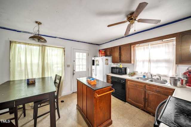 2504 Lancaster Rd NW, Wilson, NC 27896 - kitchen featuring black appliances, a center island, ceiling fan, light flooring, and pendant lighting