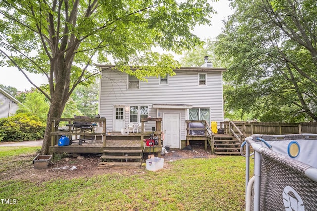 2504 Lancaster Rd NW, Wilson, NC 27896 - rear view of property featuring a wooden deck and a chimney