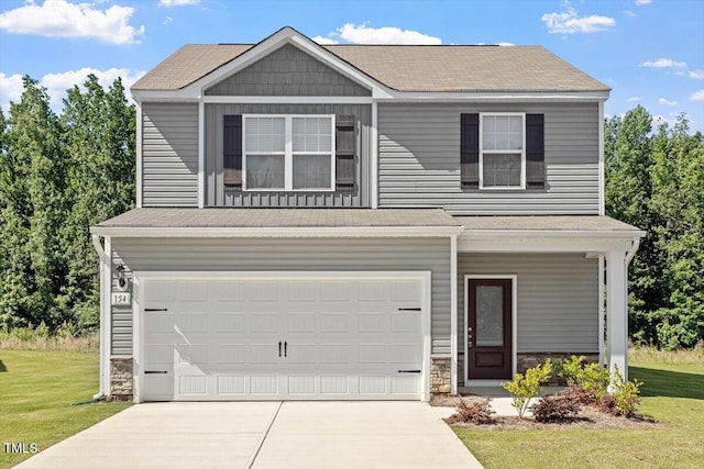 154 Taverners Ln, Angier, NC 27501 - view of front facade with stone siding, concrete driveway, a front lawn, and a garage