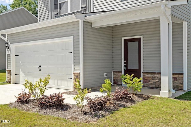 154 Taverners Ln, Angier, NC 27501 - doorway to property featuring stone siding, an attached garage, and driveway
