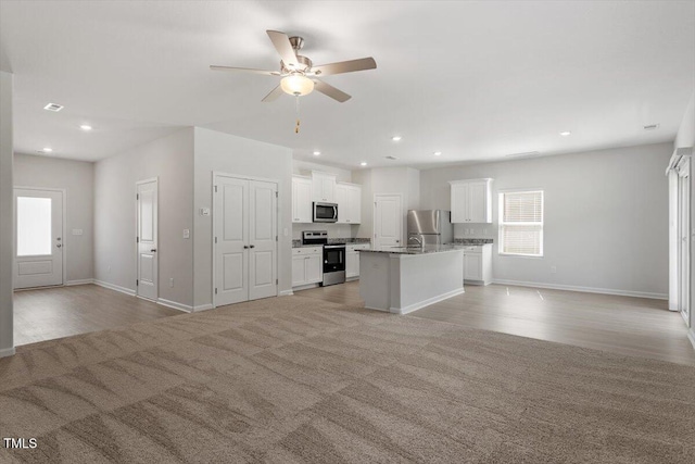 154 Taverners Ln, Angier, NC 27501 - unfurnished living room featuring ceiling fan, recessed lighting, light colored carpet, and light wood-style floors