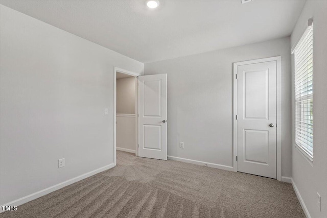 154 Taverners Ln, Angier, NC 27501 - unfurnished bedroom with multiple windows and carpet
