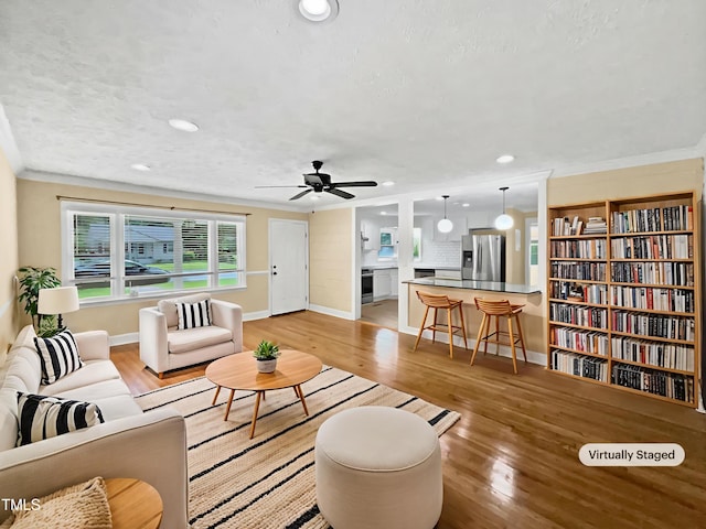 3205 Marita Dr, Fayetteville, NC 28301 - living area with light wood finished floors, recessed lighting, a ceiling fan, and crown molding