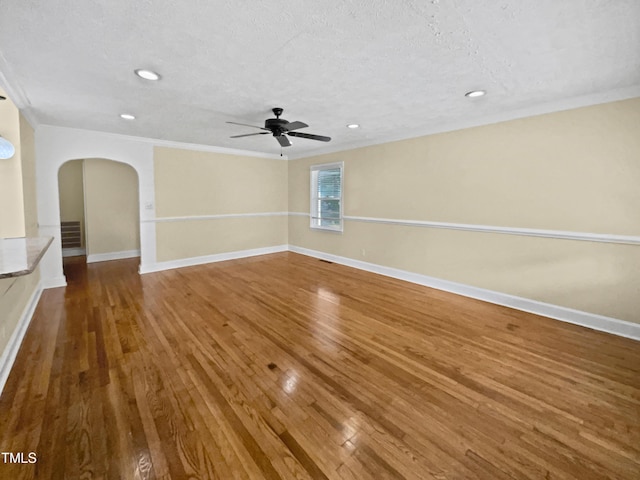 3205 Marita Dr, Fayetteville, NC 28301 - empty room with arched walkways, wood finished floors, ornamental molding, a ceiling fan, and recessed lighting