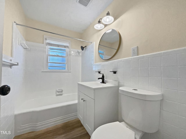 3205 Marita Dr, Fayetteville, NC 28301 - full bath with tile walls, shower / bathtub combination, wood finished floors, vanity, and a wainscoted wall