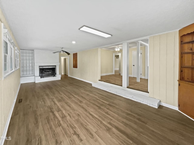 3205 Marita Dr, Fayetteville, NC 28301 - unfurnished living room with ceiling fan, wood finished floors, and a fireplace with raised hearth