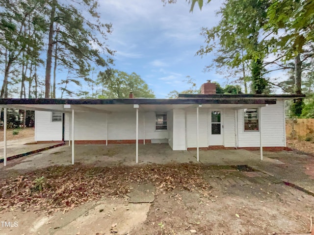 3205 Marita Dr, Fayetteville, NC 28301 - rear view of property featuring a chimney and an attached carport