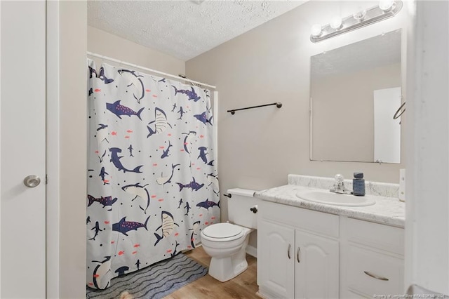 3511 Rolls Ave, Fayetteville, NC 28311 - bathroom with vanity, a textured ceiling, wood finished floors, and curtained shower