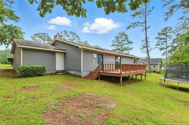 3511 Rolls Ave, Fayetteville, NC 28311 - rear view of house with a trampoline, a deck, a lawn, entry steps, and a chimney
