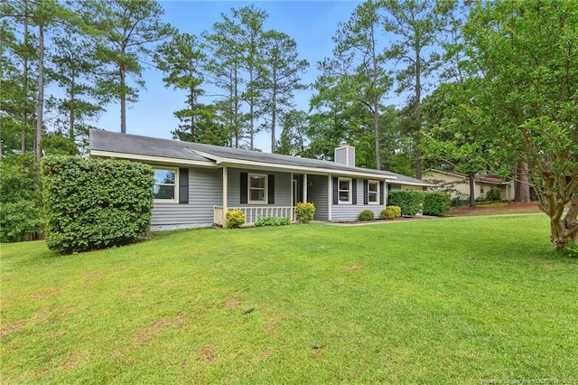 3511 Rolls Ave, Fayetteville, NC 28311 - ranch-style home with covered porch, a chimney, and a front yard