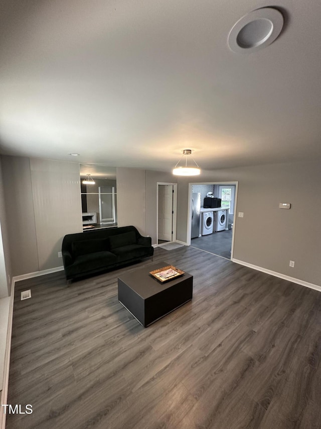 5809 Iris Lake Ct, Raleigh, NC 27604 - living room with washer and dryer and dark wood finished floors