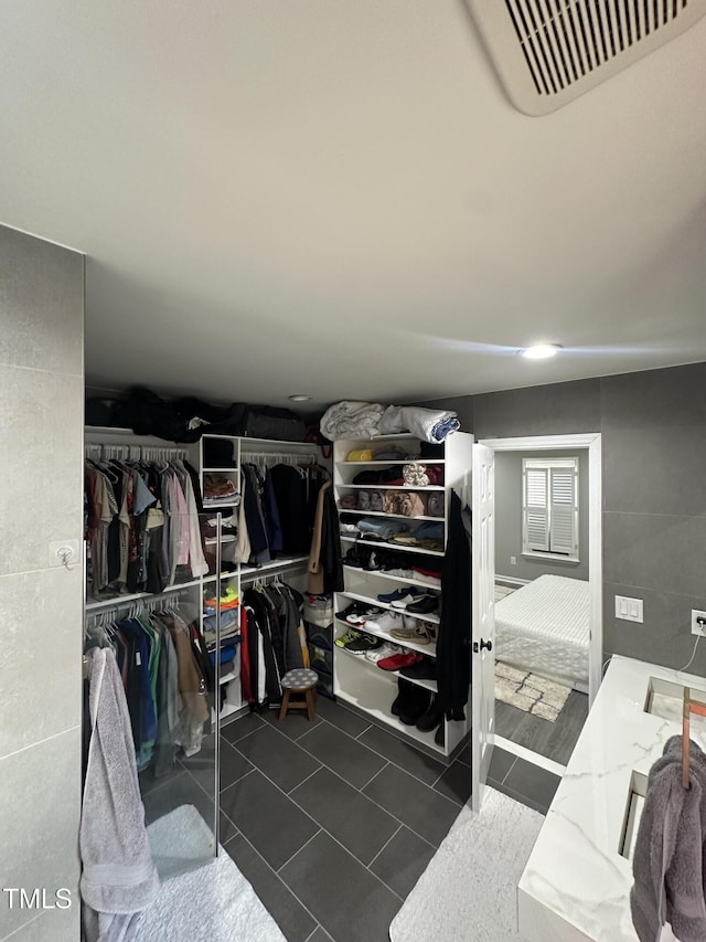 5809 Iris Lake Ct, Raleigh, NC 27604 - spacious closet featuring dark tile patterned floors
