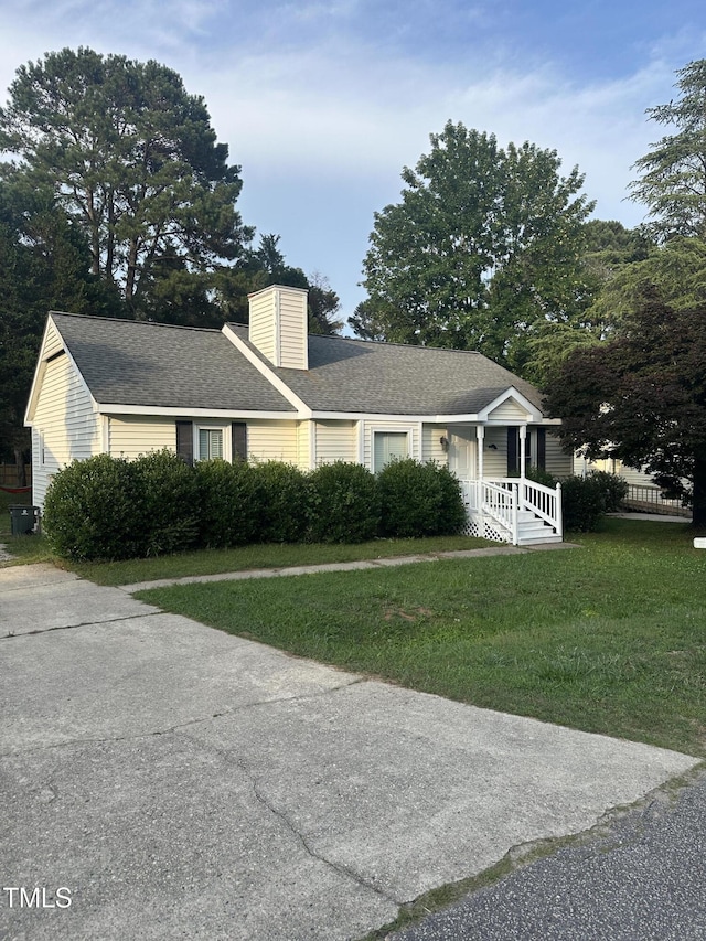 5809 Iris Lake Ct, Raleigh, NC 27604 - view of front of property with a front lawn, a chimney, and a shingled roof