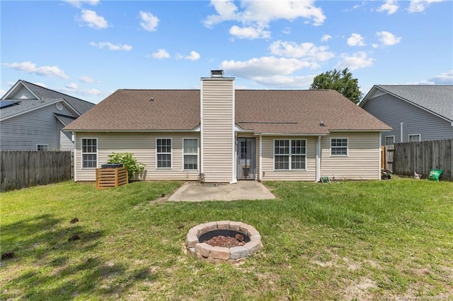 3117 Winesap Rd, Hope Mills, NC 28348 - back of house featuring a fenced backyard, a patio, a chimney, and a fire pit