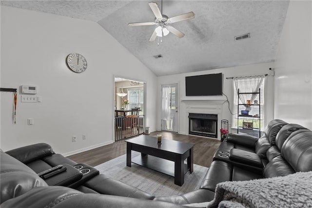 3117 Winesap Rd, Hope Mills, NC 28348 - living area featuring ceiling fan, a textured ceiling, dark wood-style floors, a fireplace, and high vaulted ceiling