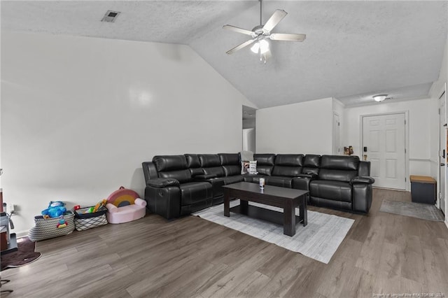 3117 Winesap Rd, Hope Mills, NC 28348 - living area with wood finished floors, a textured ceiling, a ceiling fan, and vaulted ceiling