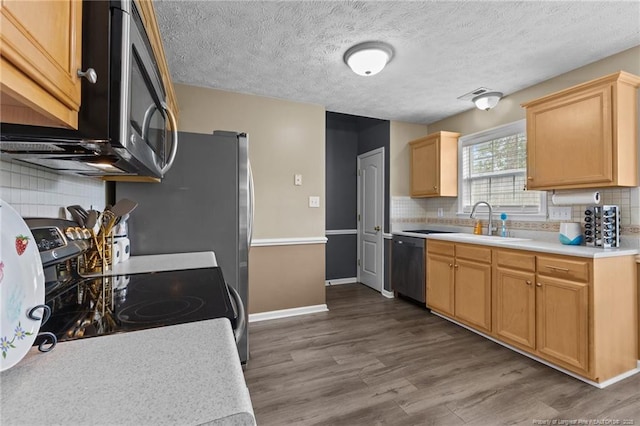 3117 Winesap Rd, Hope Mills, NC 28348 - kitchen featuring appliances with stainless steel finishes, backsplash, wood finished floors, light countertops, and a textured ceiling