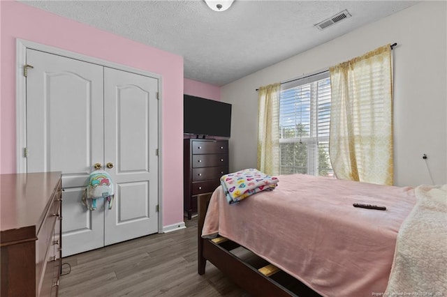 3117 Winesap Rd, Hope Mills, NC 28348 - bedroom with wood finished floors, a textured ceiling, and a closet