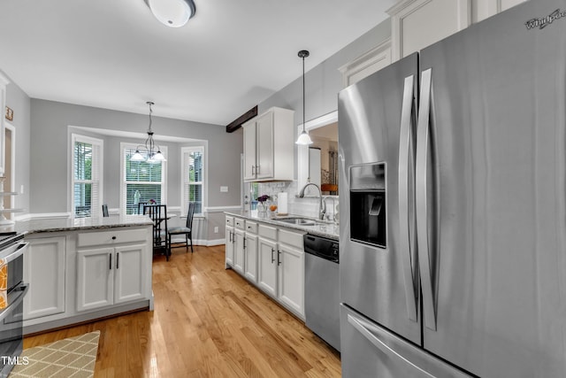 71 Smithsanders Ct, Smithfield, NC 27577 - kitchen with appliances with stainless steel finishes, white cabinetry, light wood-type flooring, and light stone countertops