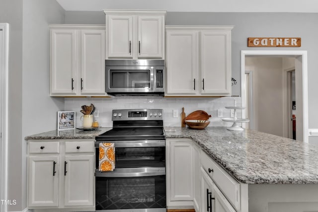 71 Smithsanders Ct, Smithfield, NC 27577 - kitchen featuring stainless steel appliances, tasteful backsplash, white cabinetry, a peninsula, and light stone countertops