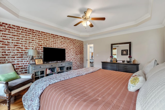 71 Smithsanders Ct, Smithfield, NC 27577 - bedroom with ornamental molding, a tray ceiling, brick wall, wood finished floors, and ceiling fan