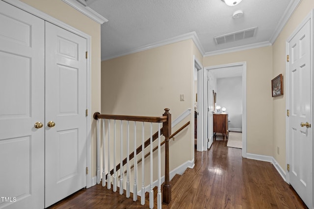 1304 Sandpiper Ct, Raleigh, NC 27615 - hallway featuring an upstairs landing, dark wood-style flooring, ornamental molding, and a textured ceiling