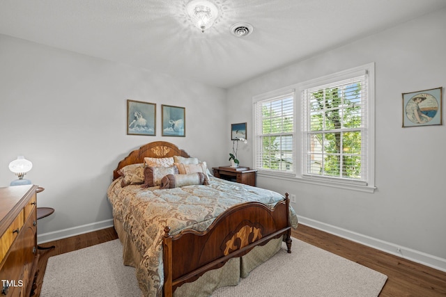 1304 Sandpiper Ct, Raleigh, NC 27615 - bedroom featuring baseboards and dark wood-style floors