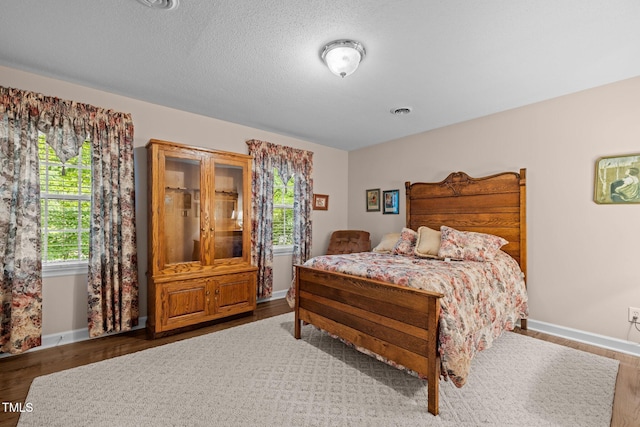 1304 Sandpiper Ct, Raleigh, NC 27615 - bedroom with multiple windows and wood finished floors