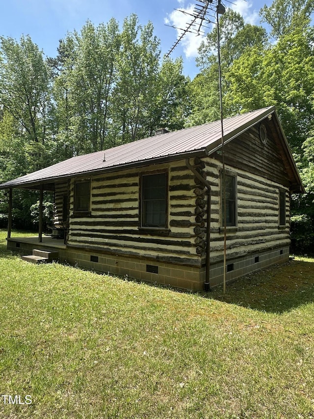2011 Bowmantown Rd, Roxboro, NC 27574 - view of front of home with crawl space, log exterior, a metal roof, and a front yard