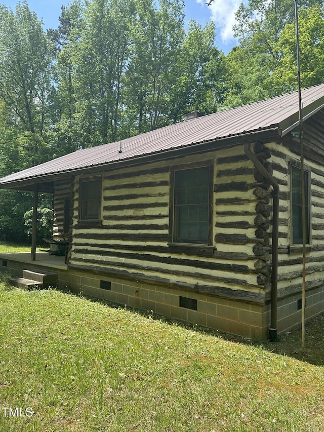 2011 Bowmantown Rd, Roxboro, NC 27574 - view of home's exterior with log siding, crawl space, a metal roof, and a yard