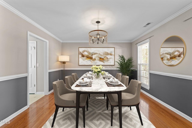 2037 Summer Shire Way, Raleigh, NC 27604 - dining space featuring wood finished floors, a chandelier, and ornamental molding