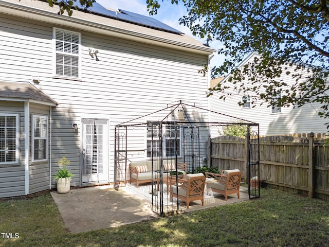 2037 Summer Shire Way, Raleigh, NC 27604 - back of property with a gazebo, outdoor lounge area, a fenced backyard, roof mounted solar panels, and a patio area