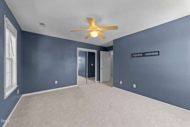 2037 Summer Shire Way, Raleigh, NC 27604 - unfurnished bedroom featuring multiple windows, light colored carpet, ceiling fan, and a closet