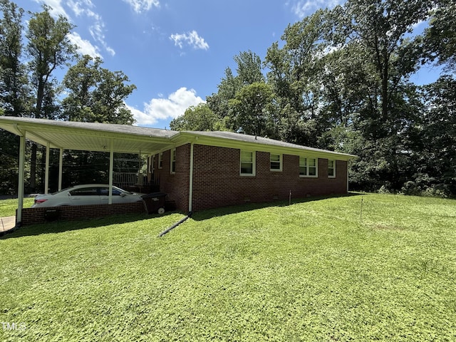 414/360 Woodsdale Rd, Roxboro, NC 27574 - view of home's exterior with a lawn, a carport, and brick siding